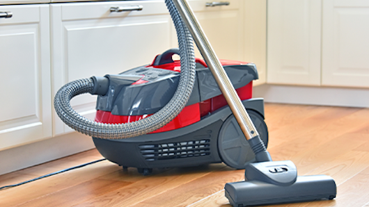 Photograph of a standard vacuum cleaner in the kitchen.