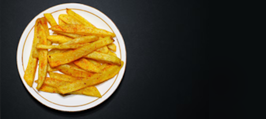 Photograph of French fries on plate.
