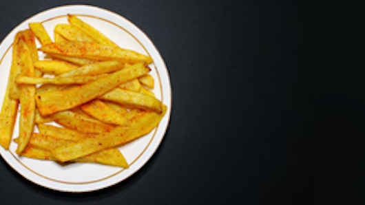Photograph of French fries on plate.