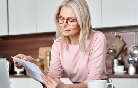 Photo of woman checking insurance bills