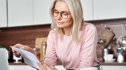 Photo of woman checking insurance bills