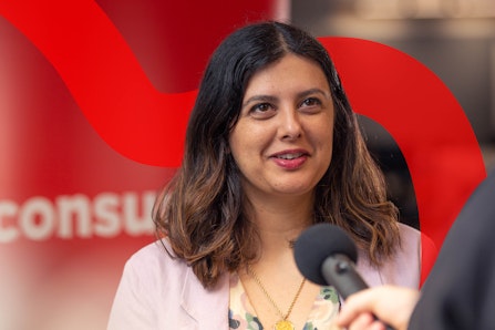 Image of a woman speaking into a microphone