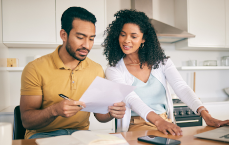 Photo of a couple looking at insurance papers