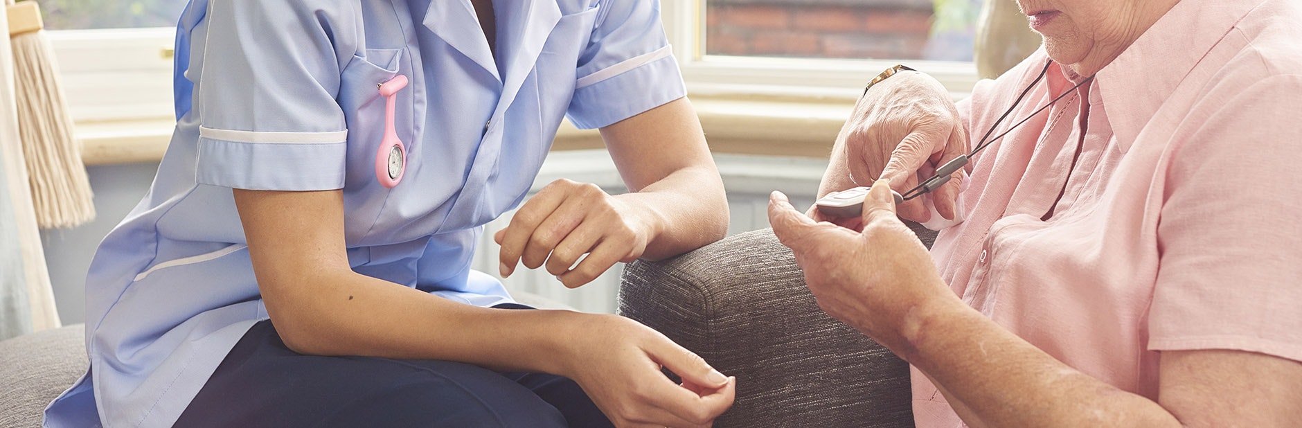 Woman and nurse with medical alarm