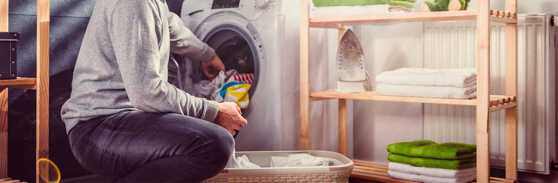 Man loading washing machine.