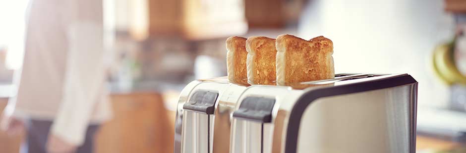 Two slices of toast in toaster.