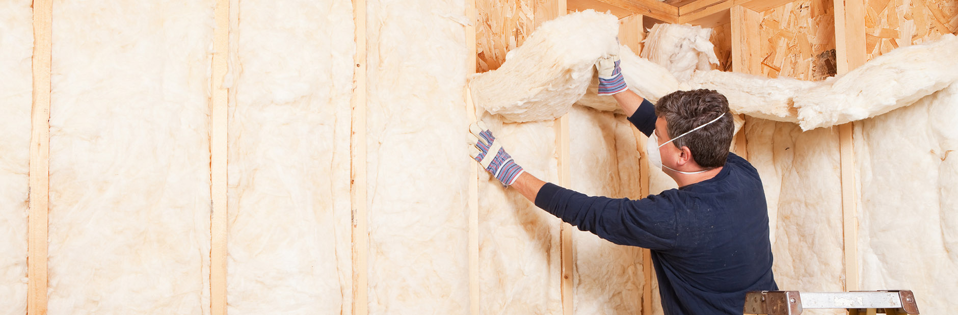 Man insulating a wall