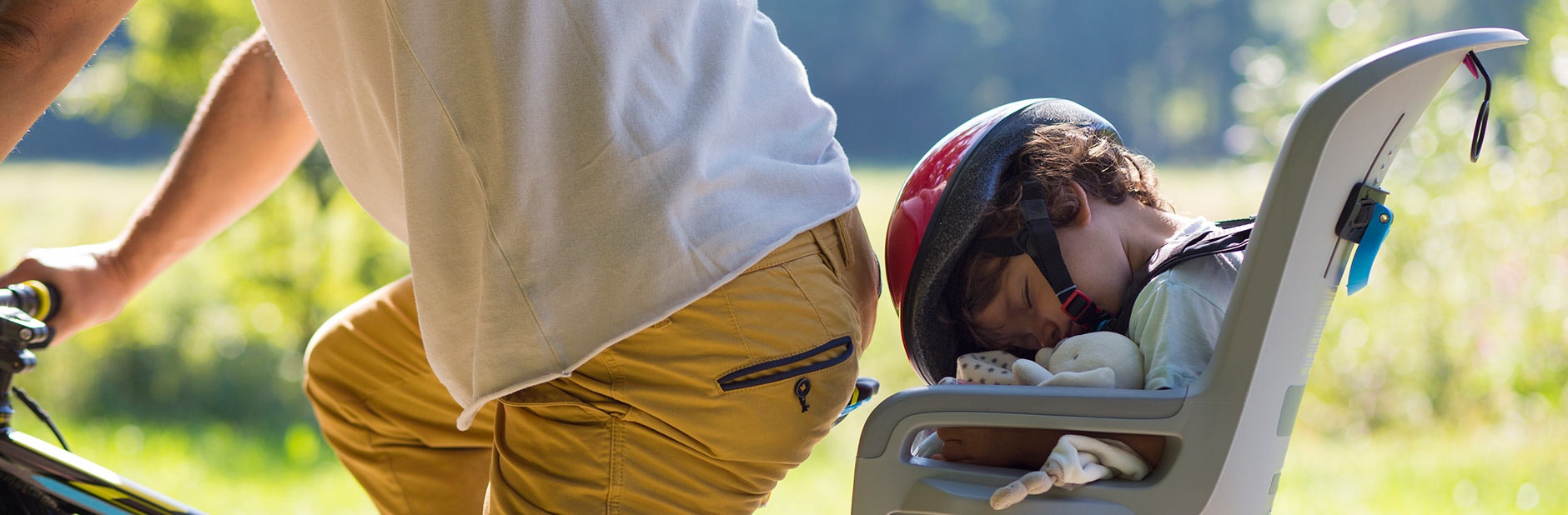 Child in rear-mounted bike seat.