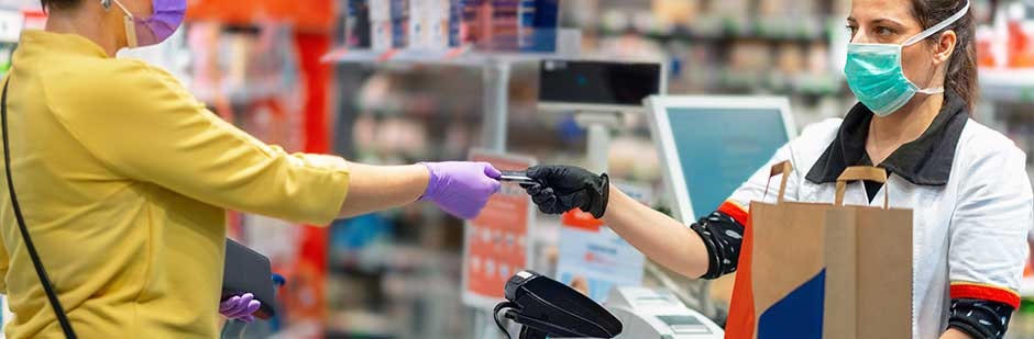 Customer and cashier making a payment in a pharmacy.