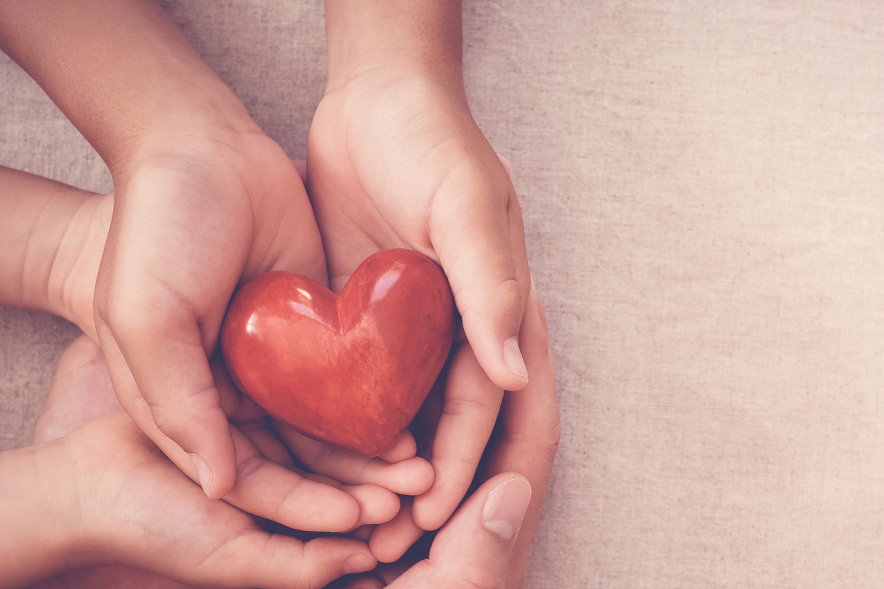 hands holding heart symbol