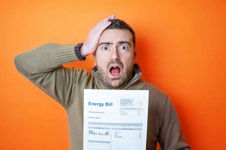 man holding energy bill