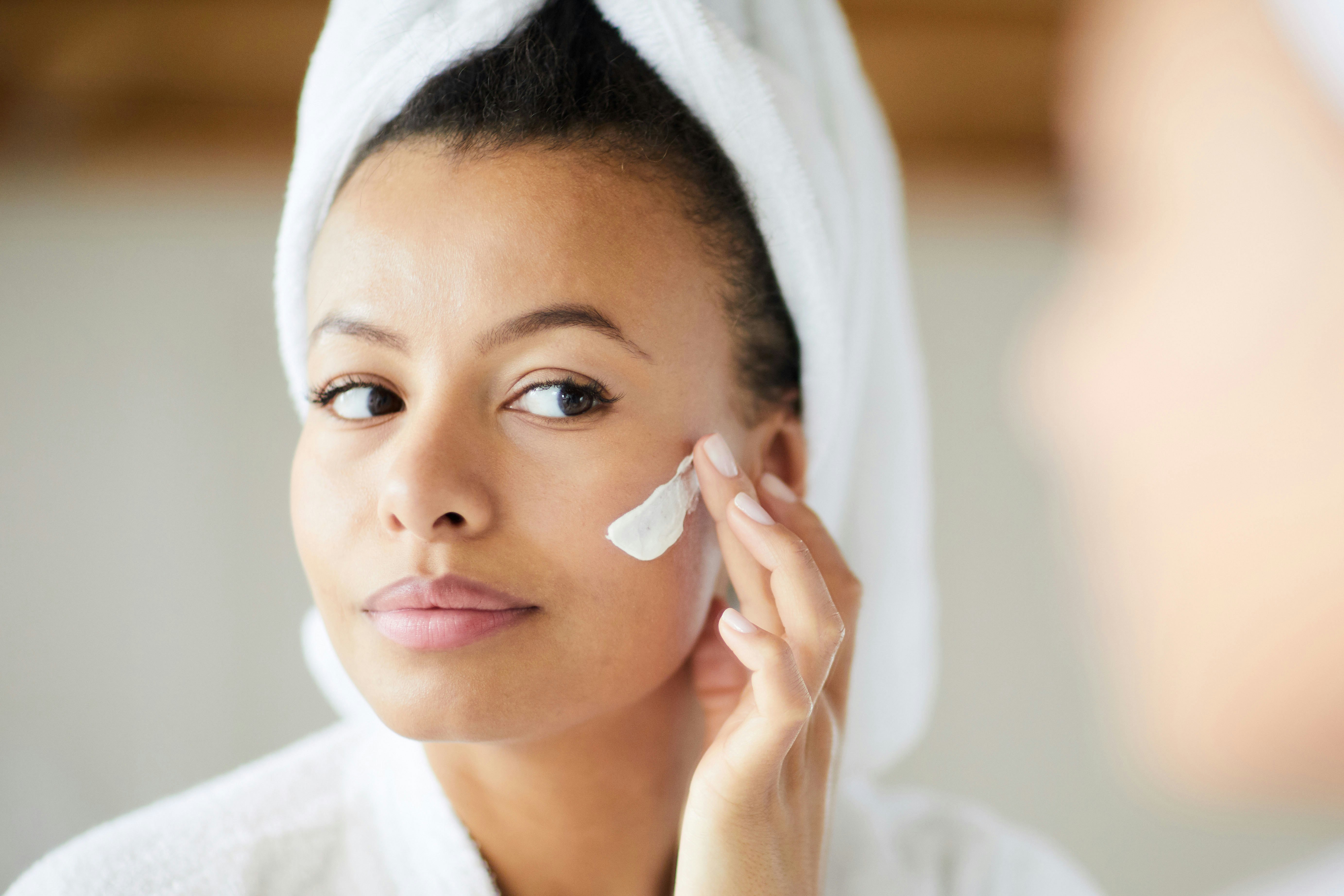 Image of a woman applying skin product