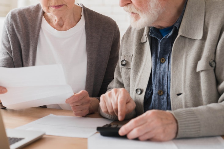 Elderly looking at invoices