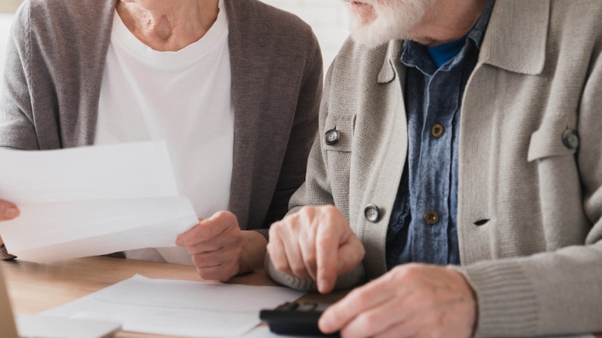 Elderly looking at invoices