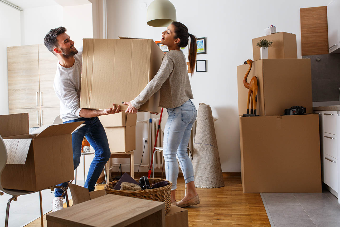 Young couple moving boxes together.