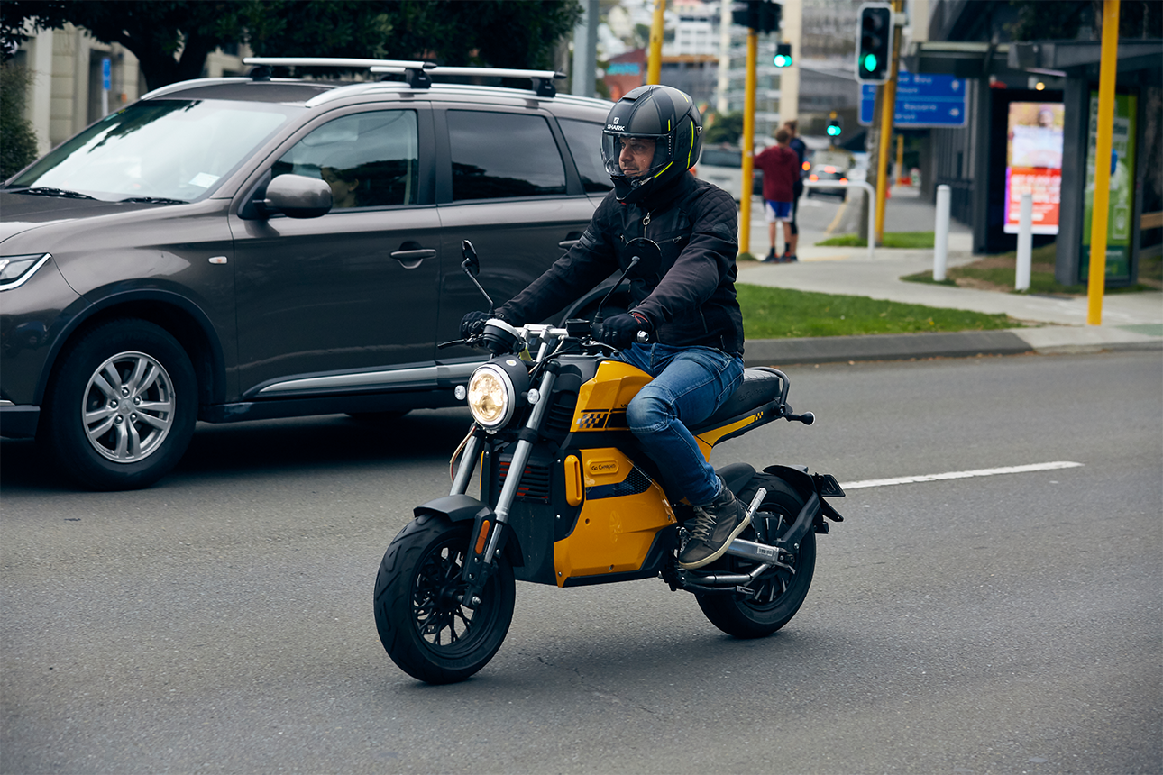 Person riding e-moped in town.
