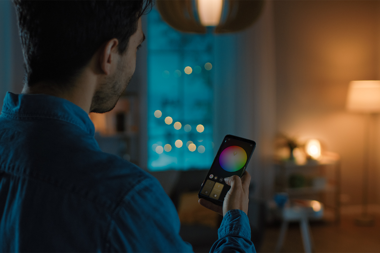 Person using Philips Hue smart lights.