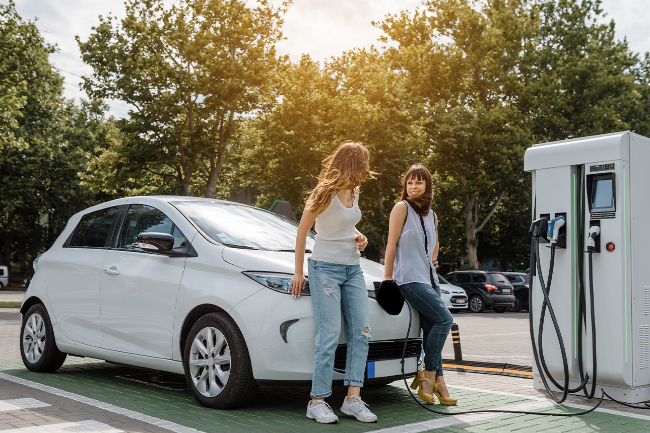 Women charging electric car.