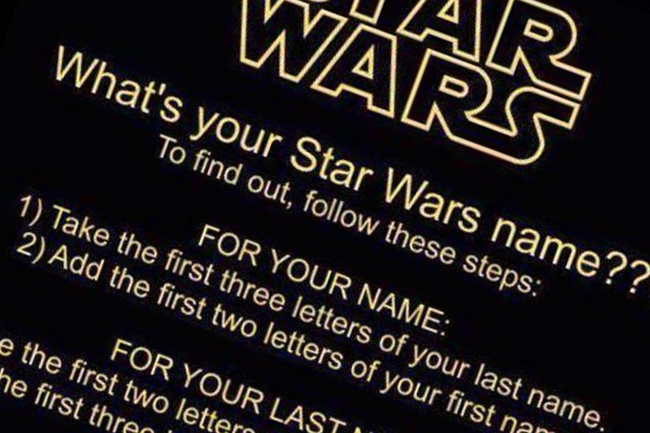 Young couple looking at mobile phone, sitting on the ground at home.