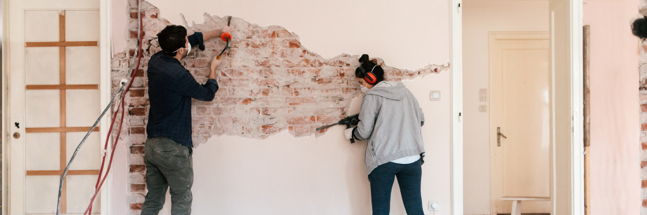 Young couple working on reconstruction of their apartment.