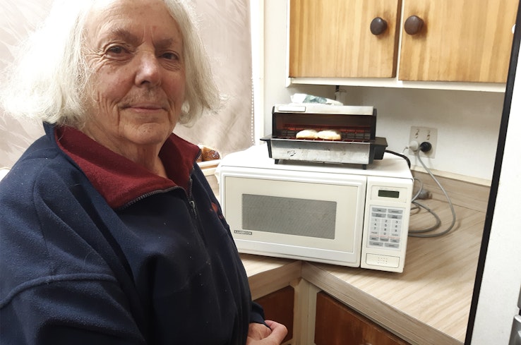 Lady next to old toaster.