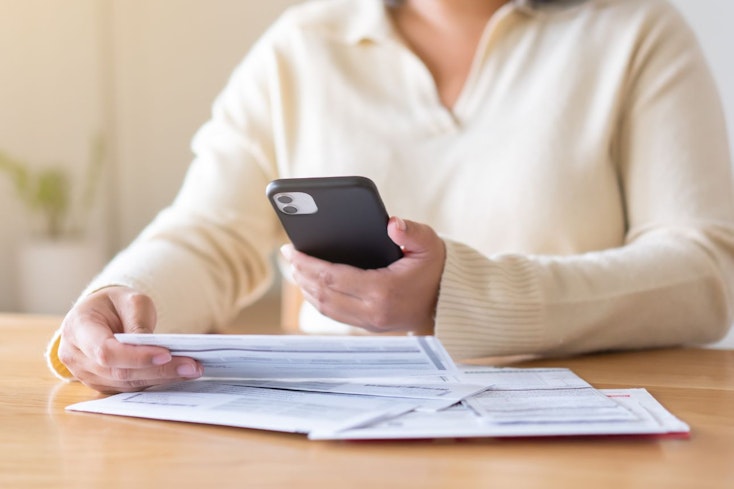 Consumer nz website promo image  a woman reviews her power bill width