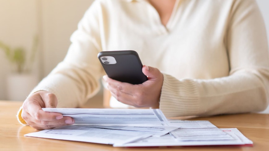 Consumer nz website promo image a woman reviews her power bill width