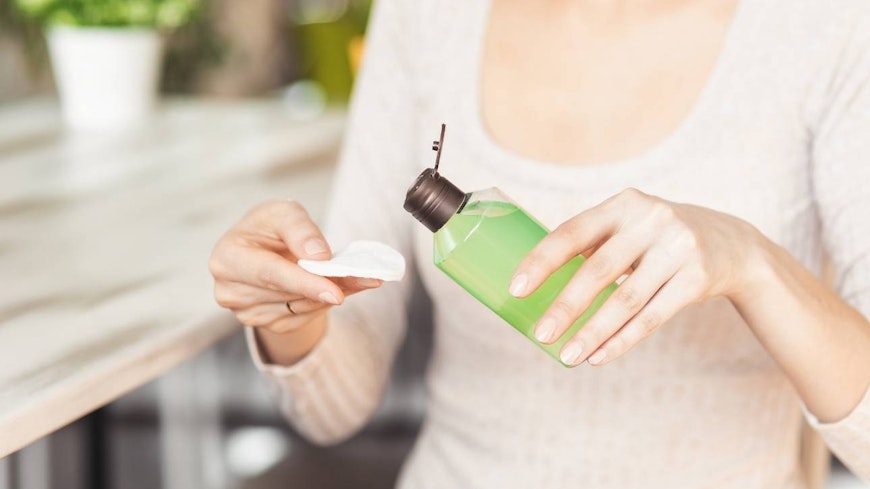 Image of a woman using make up remover
