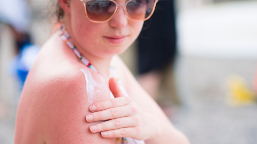Woman applying sunscreen