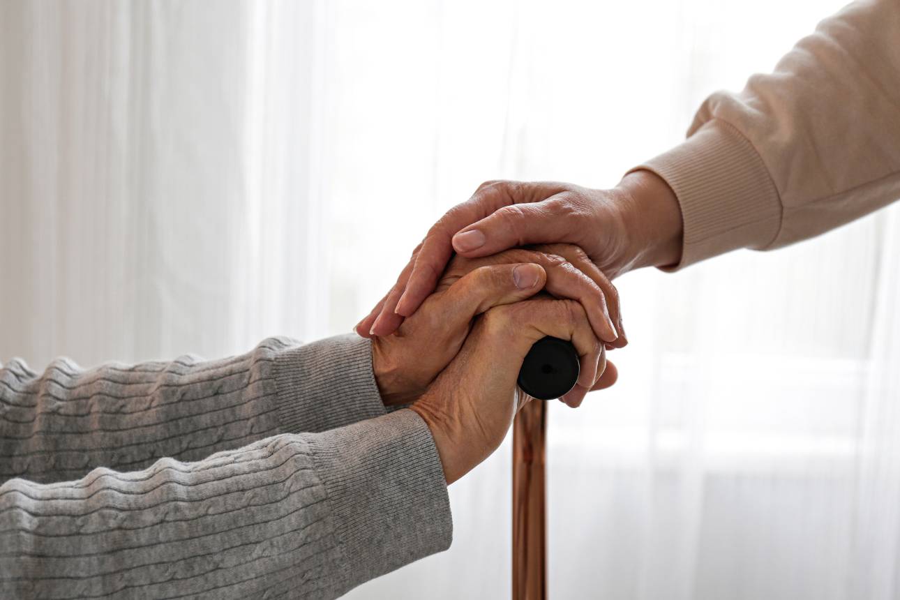 Image of an elderly holding a walking stick