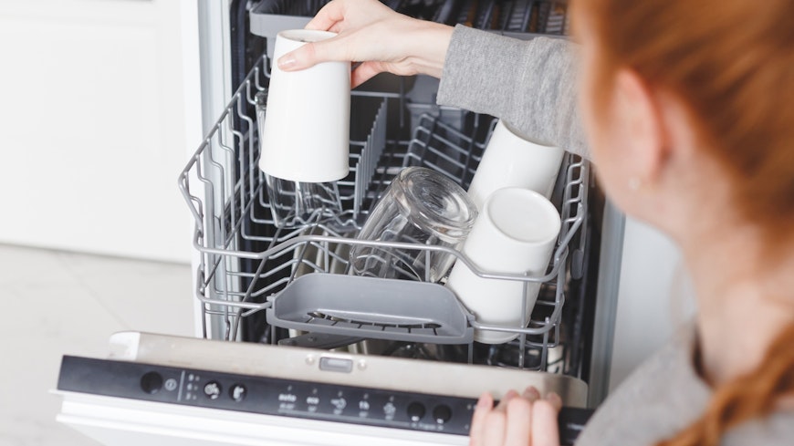 Image of a woman loading the dishwasher