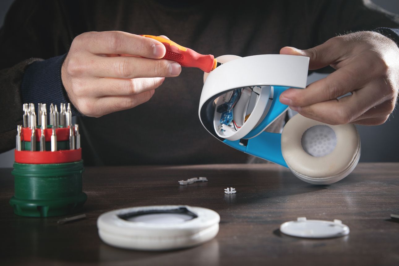 Image of a man repairing headphones