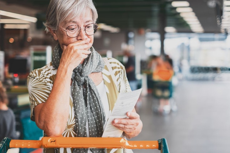 Image of woman looking at her supermarket receipt