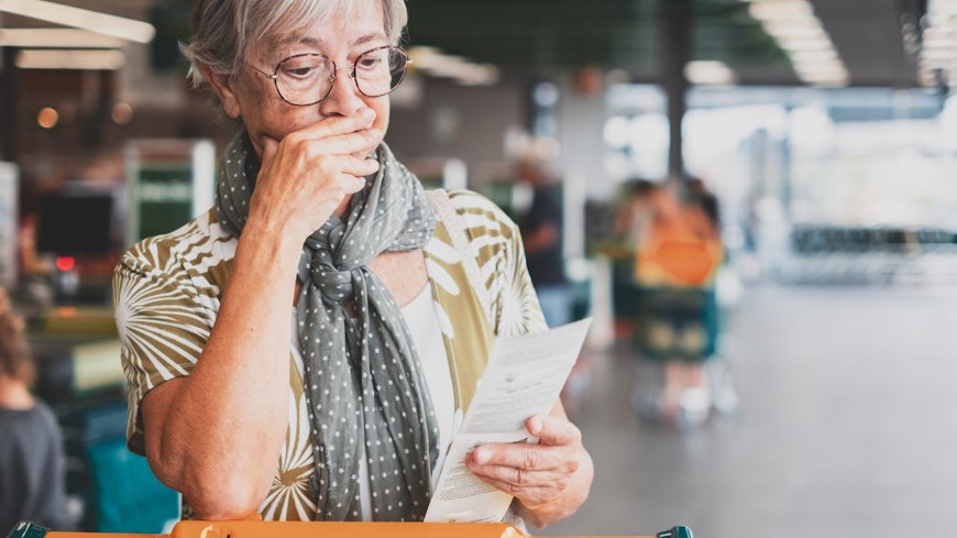 Image of woman looking at her supermarket receipt