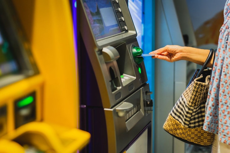 Image of a woman using an ATM machine