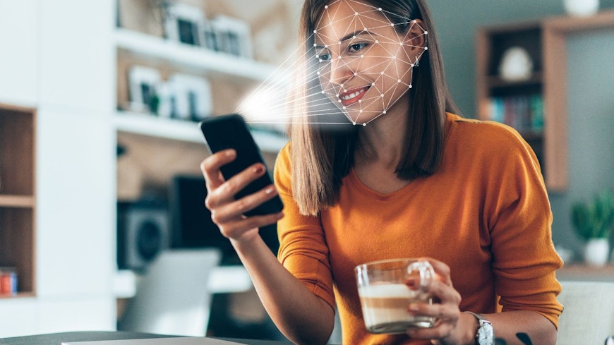Image of a woman using facial ID to unlock phone
