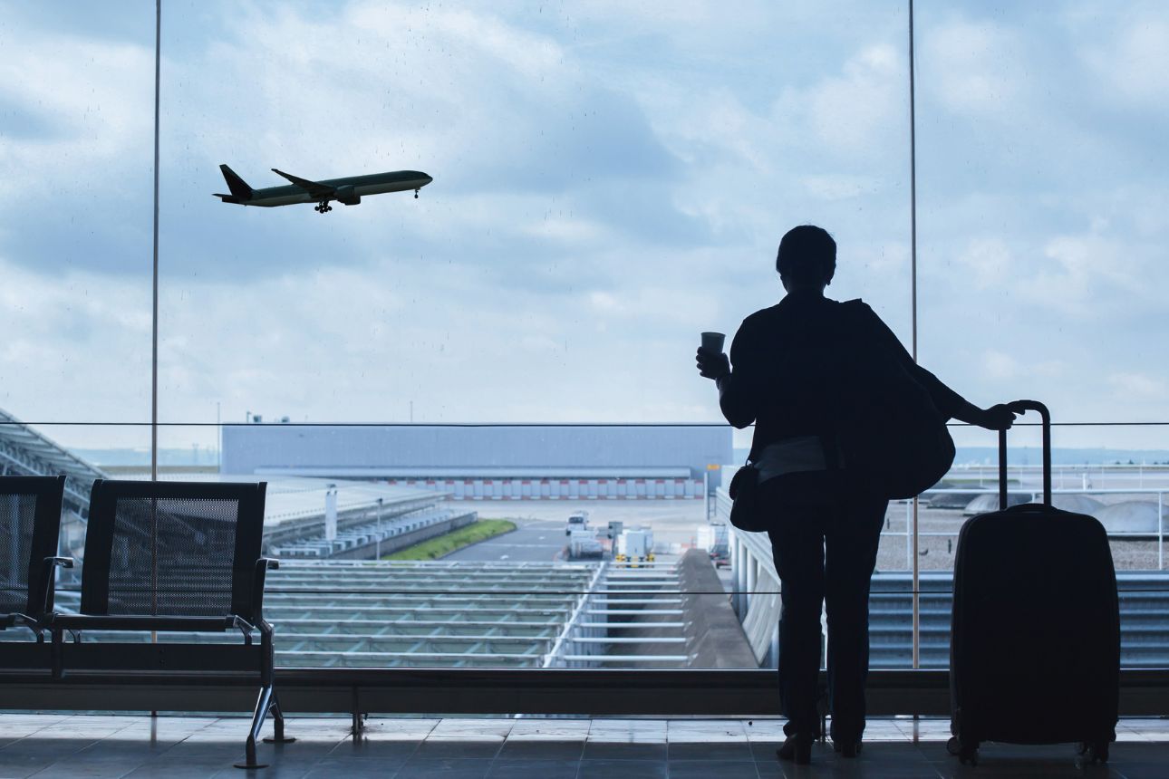 Image of a woman watching a plane fly