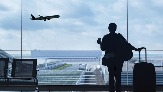Image of a woman watching a plane fly