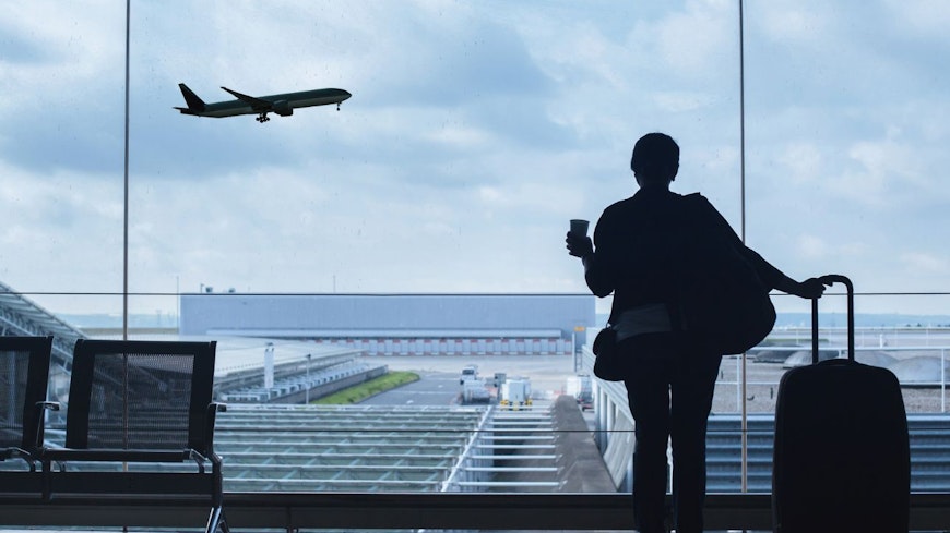 Image of a woman watching a plane fly