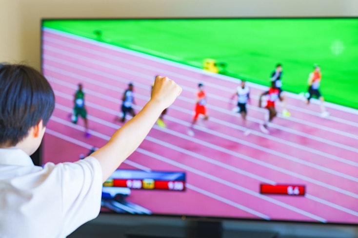 Image of a boy watching sports on the TV