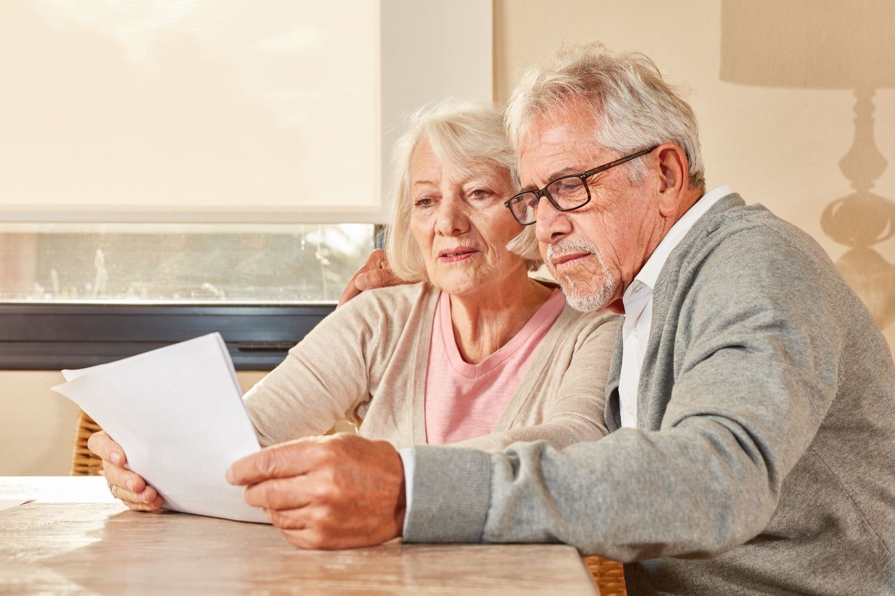 Image of an elderly couple reading a contract