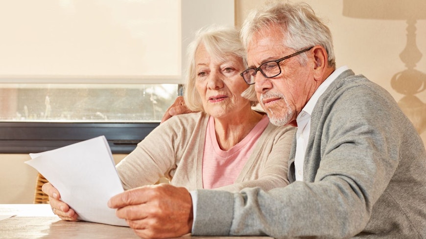Image of an elderly couple reading a contract