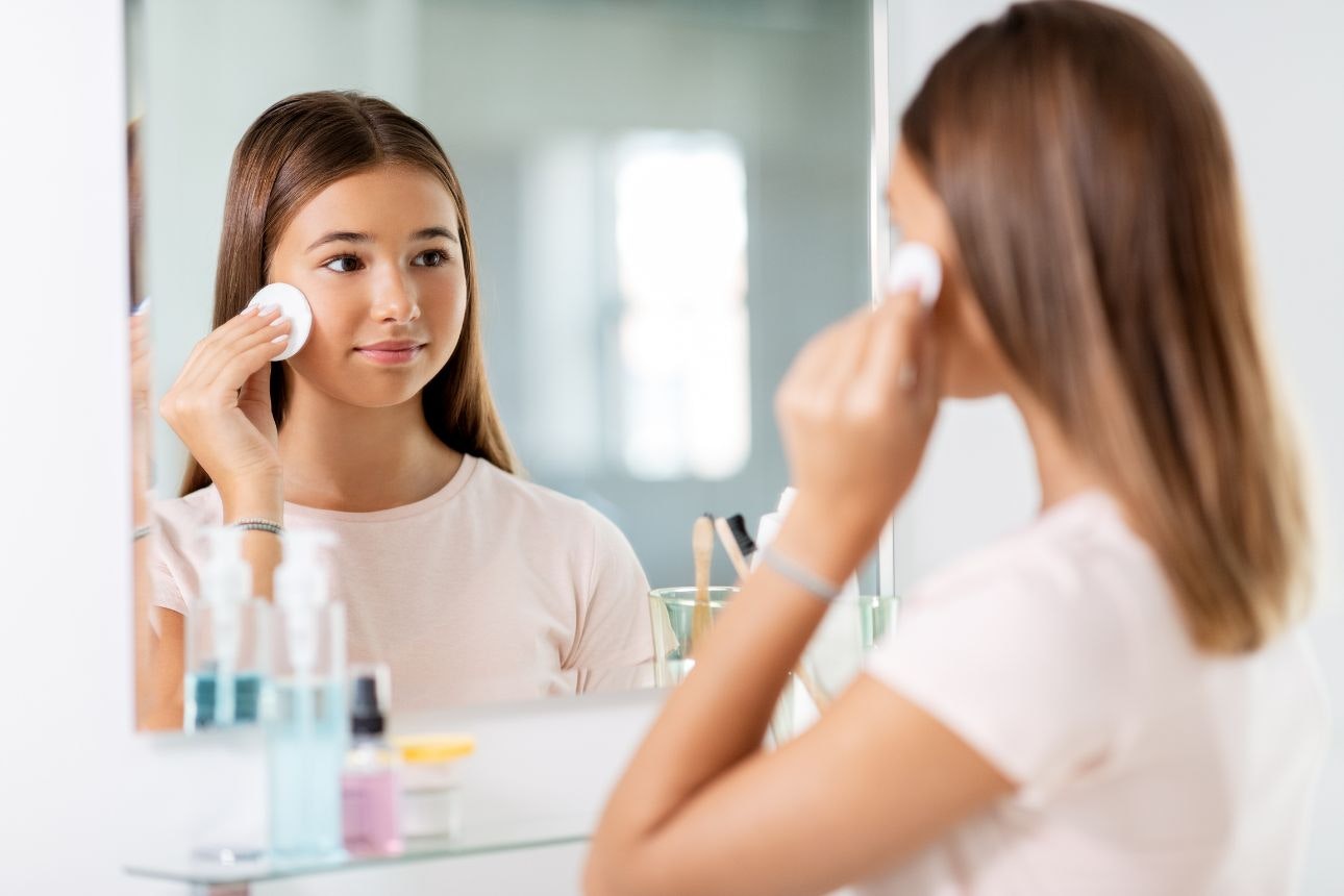 Image of a teenager applying skincare
