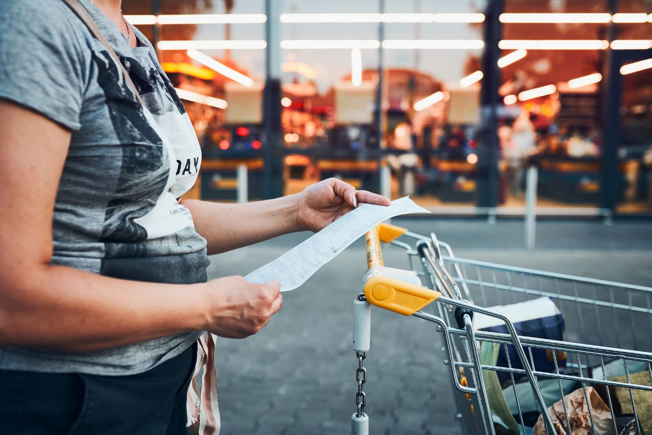 Image of woman looking at shopping receipt
