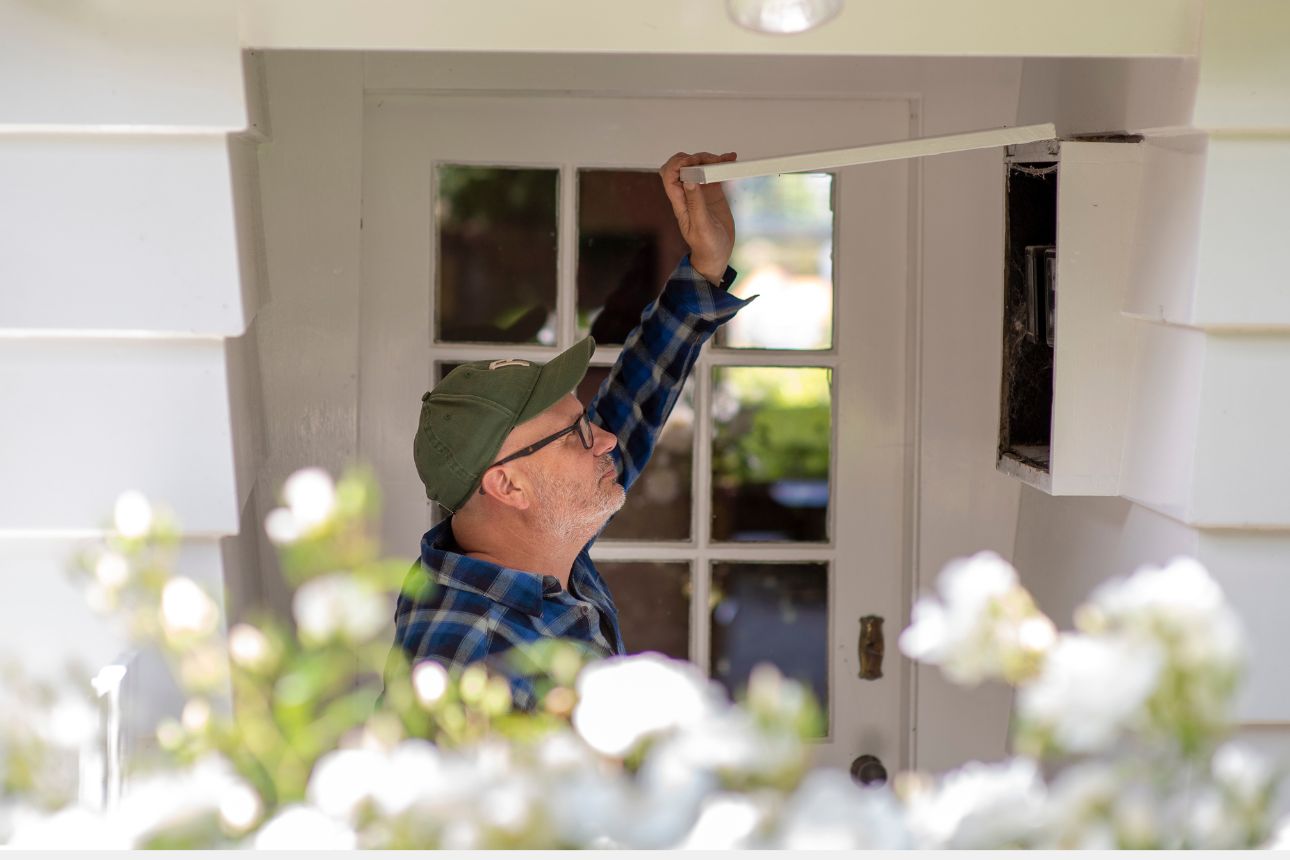 Image of a man opening circuit box