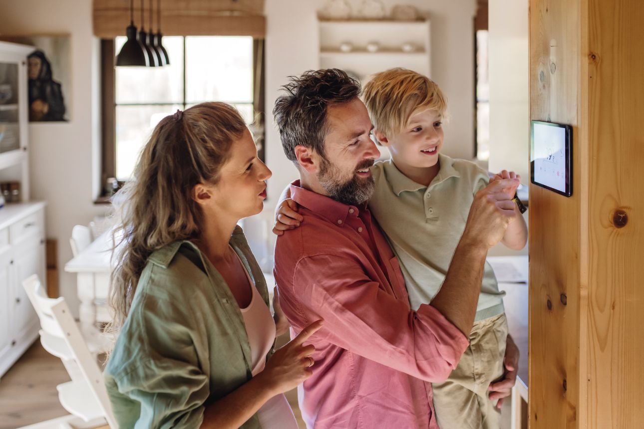 Photo of a family looking at a thermostat