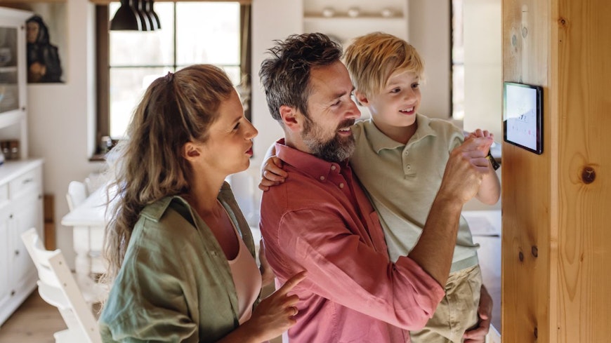 Photo of a family looking at a thermostat