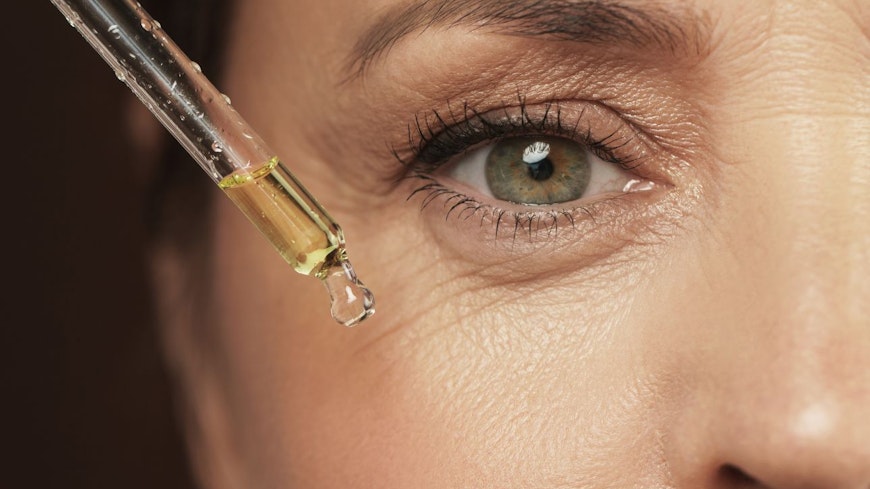 Image of woman applying serum