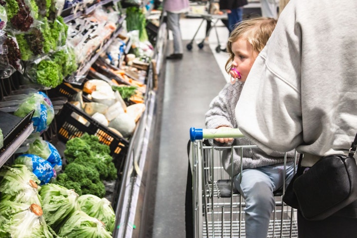 Image of a woman with her baby at the supermarket