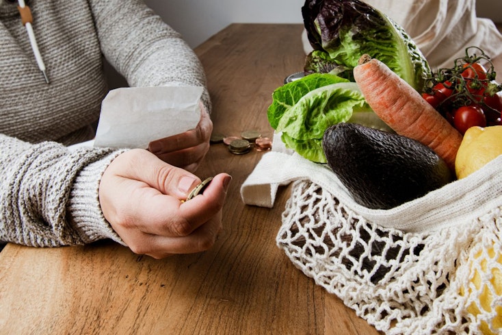 Woman looking at supermarket receipt
